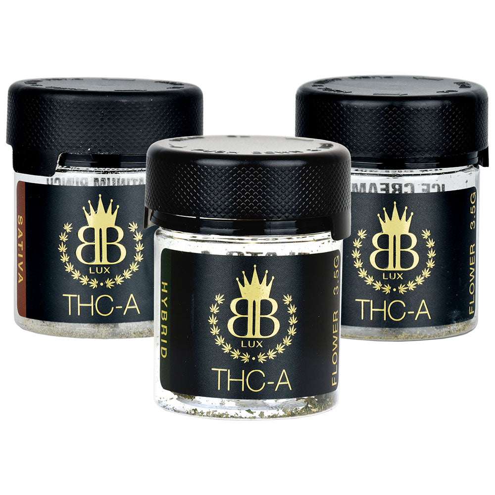 Three black containers with gold crowns labeled THC-A, part of Budzburn Lux THCA Flower