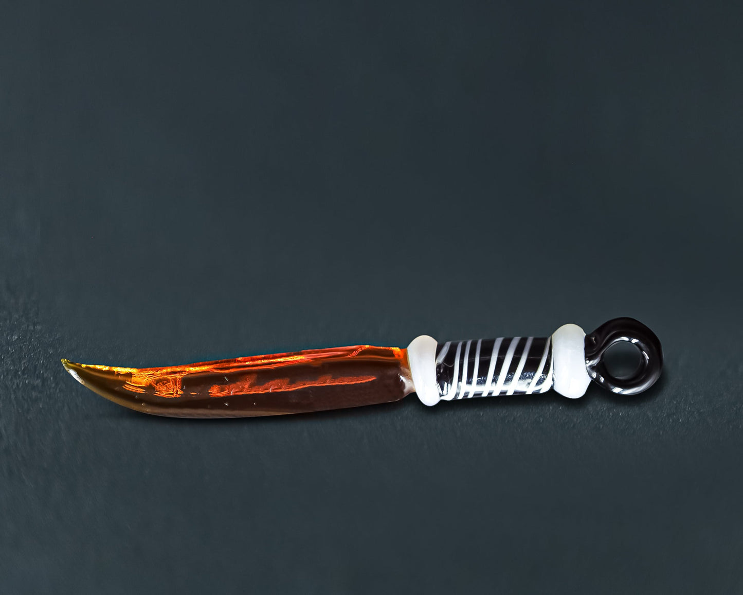 Glass pipe with striped stem and amber bowl for the ultimate Sword Dab Tool experience