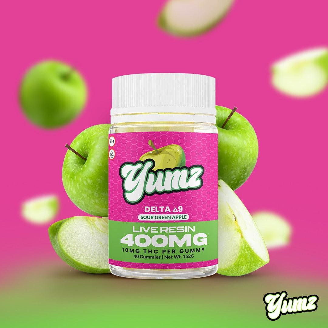 Pink Yumz Delta-8 gummy container with sour green apple gummies and apples around it